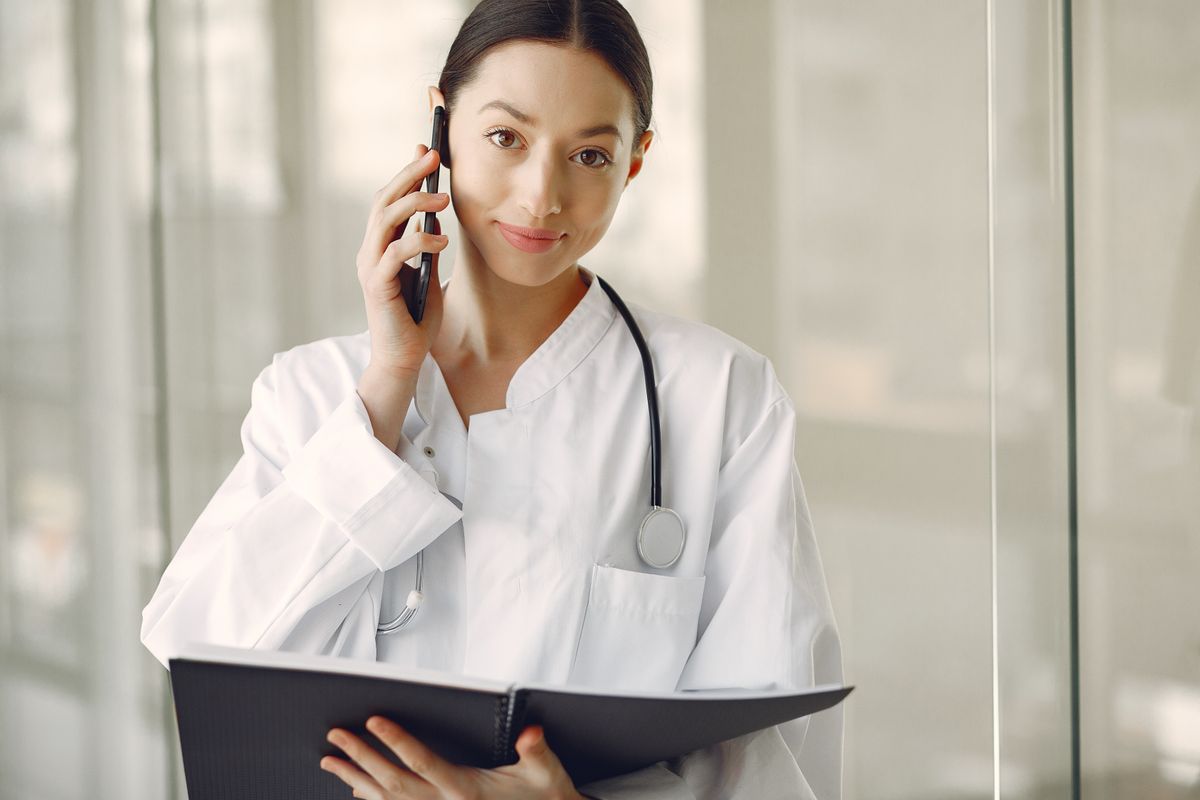 Healthcare professional on a phone in a clinic, illustrating a StraightDesk use case